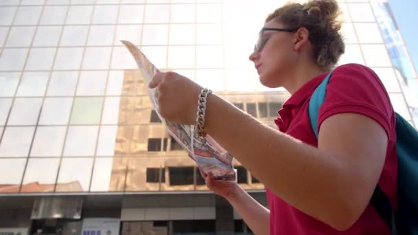Schöne kaukasische reisende Frau beim Lesen einer Landkarte — Stockvideo