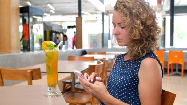 Cafe City Stile di vita donna con succo di frutta utilizzando il telefono — Video Stock