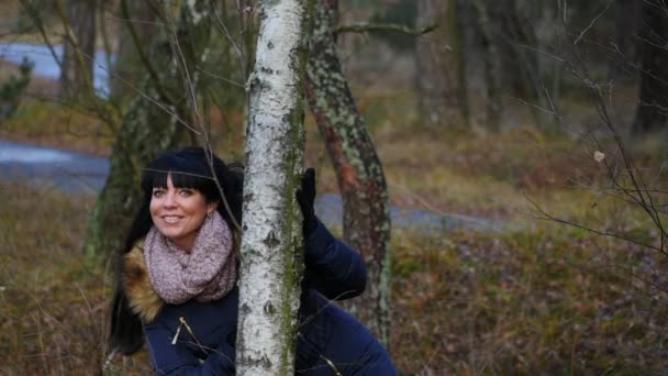 Mujer en ropa de abrigo se mueve y posando en el bosque a cámara lenta — Vídeos de Stock