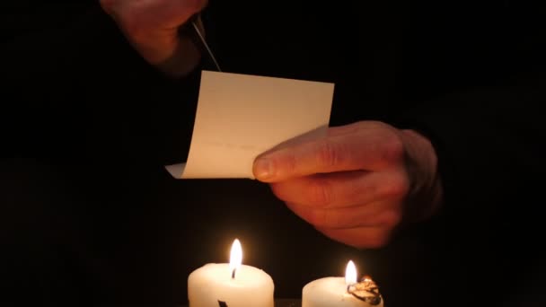 Isolated hands on black making black magic ritual, poke knife into photography — Stock Video