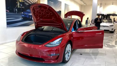Orlando, FL/USA-2/17/20:  A Tesla Model 3 at a Tesla retail store.  Tesla is an electric automobile company owned by Elon Musk. clipart