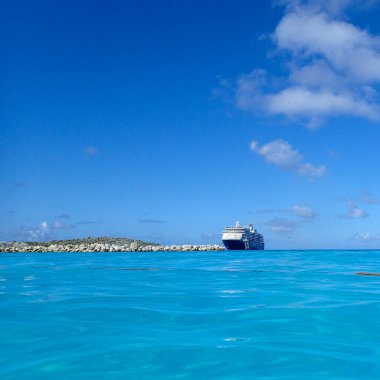 Half Moon Cay / Bahamas-10 / 31 / 19: Hollanda Amerika Hattı Zuiderdam yolcu gemisi güneşli bir günde Bahamalar 'daki Half Moon Cay adasına demir attı.