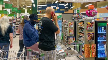 Orlando, FL USA - March 12, 2020:  The long lines at typical grocery with carts  filled with food and disinfectant at a Publix grocery store due to the people panicking and hoarding products clipart