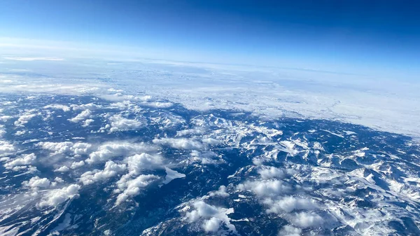 雲と明るい青空の飛行機の窓からの空の景色 — ストック写真