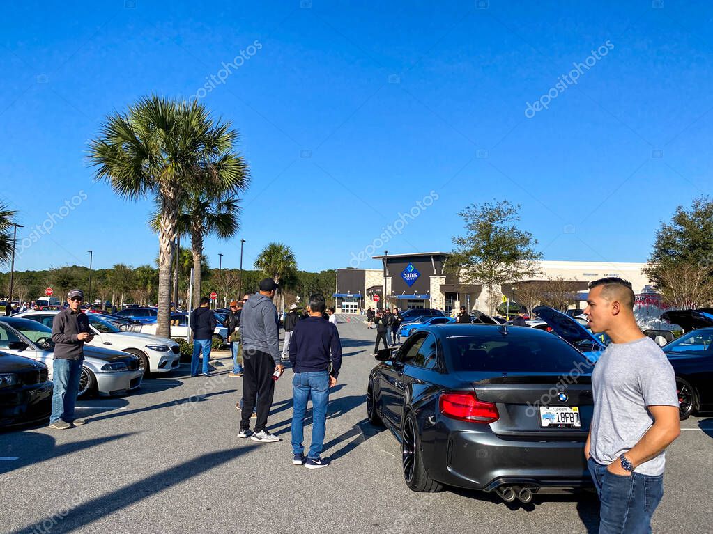 Orlando, FL USA  - March 1, 2020: People browsing at automobiles at a free to the public Cars and Coffee car show.