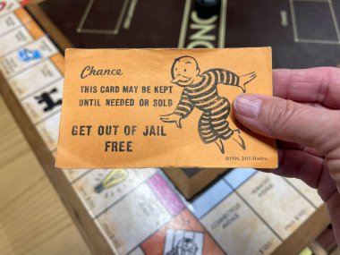 Orlando,FL USA - January 25, 2021:  A get out of Jail Free card from a monopoly set.  Concept pardon, presidential, business, banking and finance. clipart