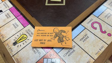 Orlando,FL USA - January 25, 2021:  A get out of Jail Free card from a monopoly set.  Concept pardon, presidential, business, banking and finance. clipart