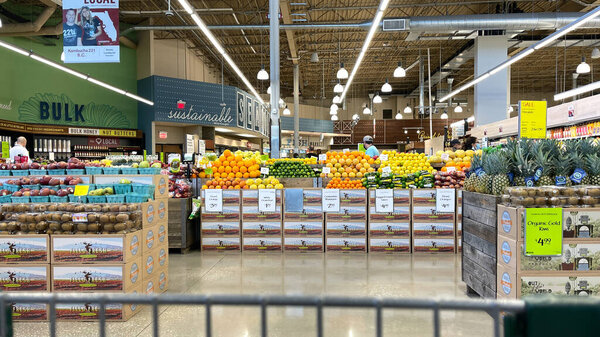 Orlando,FL USA - January 18, 2021:  The produce aisle with a cart point of view of a Whole Foods Market grocery store in Orlando, Florida.
