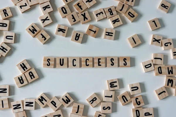 The word success spelled out in wooden craft letters surrounded by letters.  Concept business, government, president, and money.