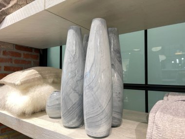  A knick knack  display with vases and pillows at a Midcentury Modern furniture store in Orlando, Florida.