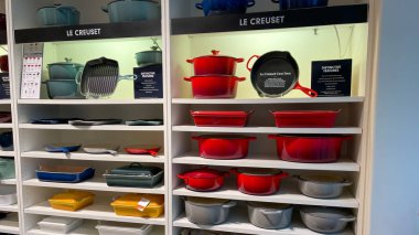 Orlando, FL USA -  September 9, 2021: The Le Creuset pot and pan aisle at a Williams Sonoma store at an indoor mall in Orlando, Florida. clipart