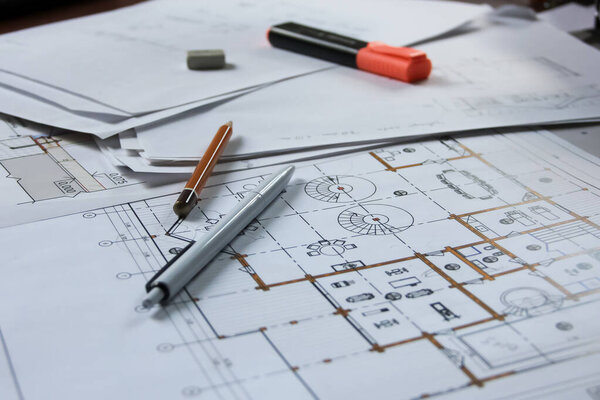 architectural plan with stationery on the table