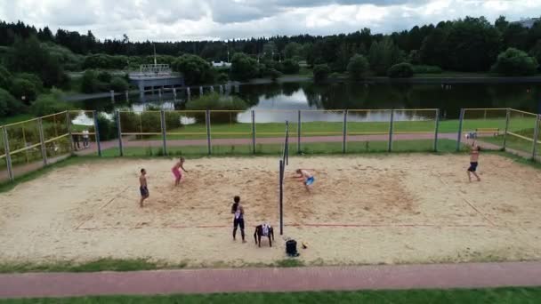 Competições de vôlei de praia na costa do lago. — Vídeo de Stock