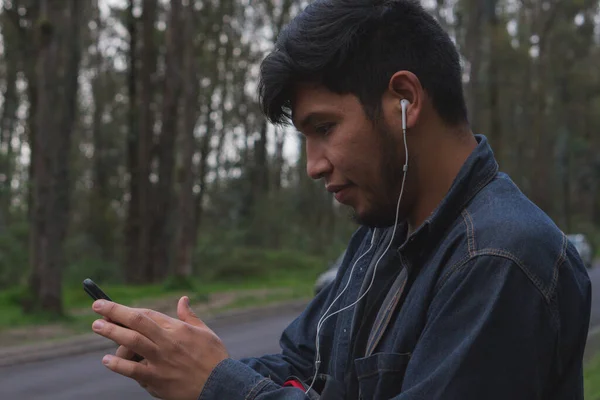 Jovem Ouvindo Música Seu Celular Passeando Pela Floresta — Fotografia de Stock