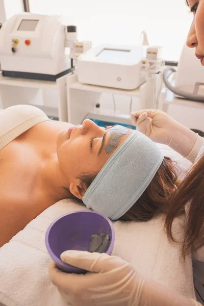 Young Woman Enjoying a Day at the Spa. Performing different treatments for the care of your skin and face.