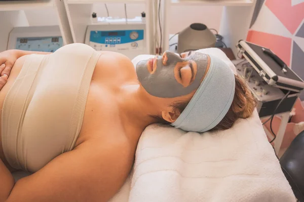 Young Woman Enjoying a Day at the Spa. Performing different treatments for the care of your skin and face.