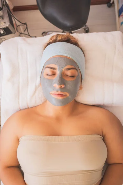 Young Woman Enjoying a Day at the Spa. Performing different treatments for the care of your skin and face.