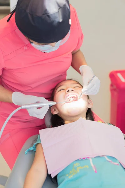 在牙科诊所接受牙科治疗的女孩照顾你的牙齿和牙具 — 图库照片