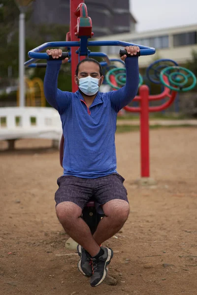 New normal. man with mask or mask mask and sportswear exercises in the park. Sport session