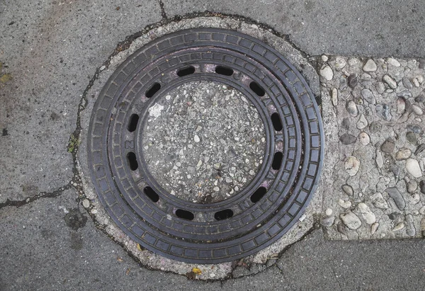 sewer manhole decorated with stone in Slovenia
