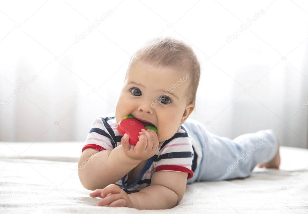 baby is nibble a rubber toy because the childs teeth are being cut