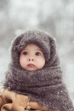 Kışın yün şallı sevimli bir bebeğin retro fotoğrafı.