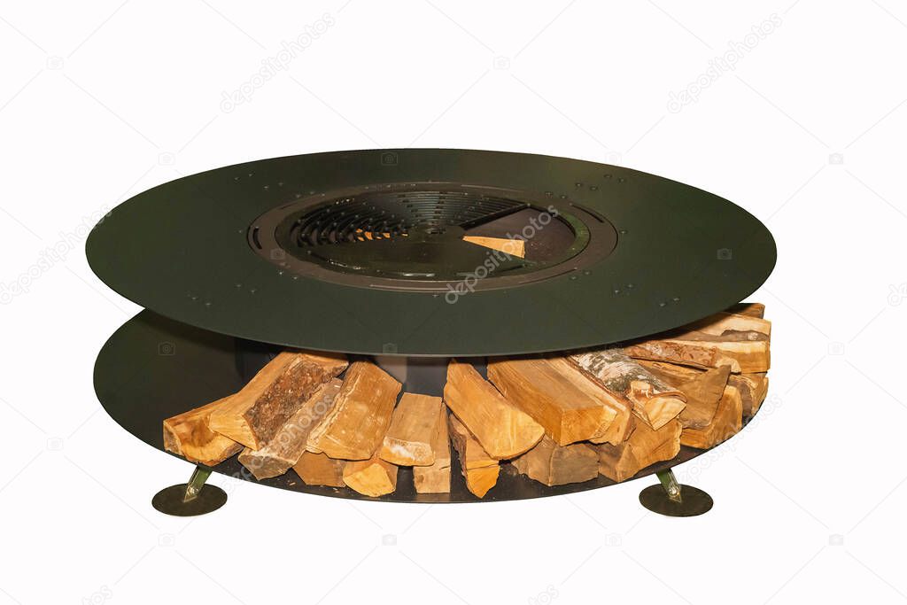 Huge round grill with firewood on white background. Garden equipment for a picnic