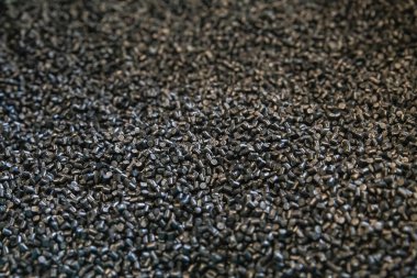 black granules for the production of plastic products clipart