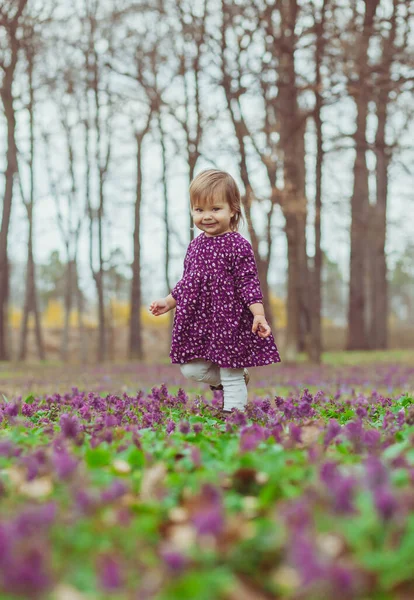 Ξανθό Μωρό Ένα Χρωματιστό Φόρεμα Περπατά Ένα Ξέφωτο Δάσος Λουλούδια — Φωτογραφία Αρχείου