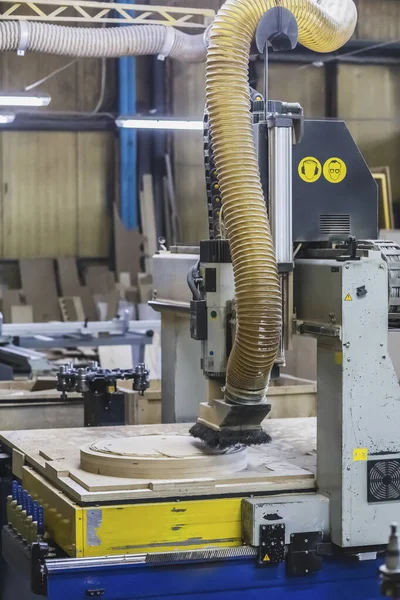 CNC machine cuts a round piece at the factory