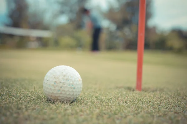 Golfbal op lip van gat — Stockfoto