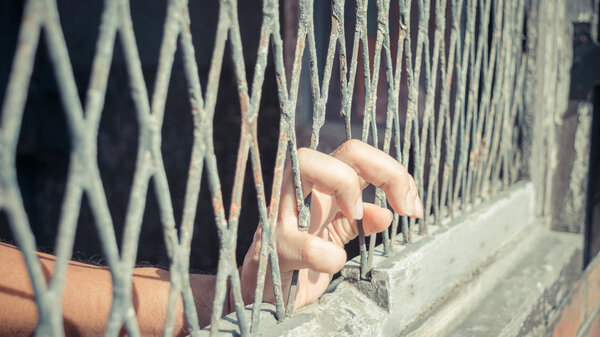 Hands of the man on a steel lattice close up