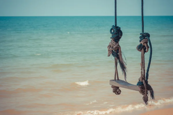 Swing at beach and blue sea Stock Photo