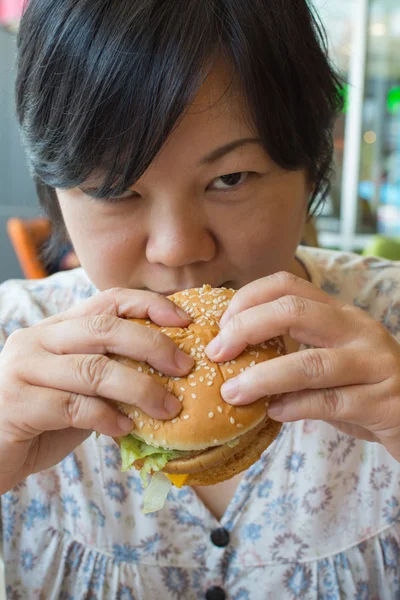 Bir hamburger yeme Asya kadın — Stok fotoğraf