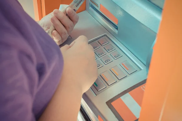 Automated teller machine (ATM) with person have a banknote in ha