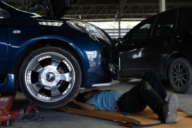 Bangkok, Tayland - 31 Ağustos 2017: Tanımlanamayan araba tamircisi veya tamircisi araba tamirhanesinde veya tamirhanede tamir ve onarım sorunları için araba motorunu kontrol ediyor