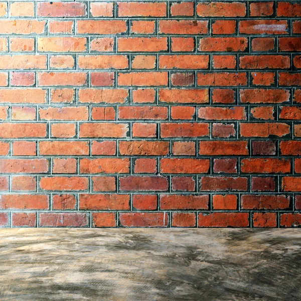 Polished bare concrete floor and red brick wall — Stock Photo, Image