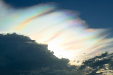 Rare fire rainbow in dark stormy clouds.