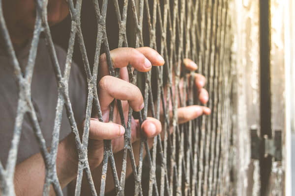 Hands of the man on a steel lattice close up vintage style