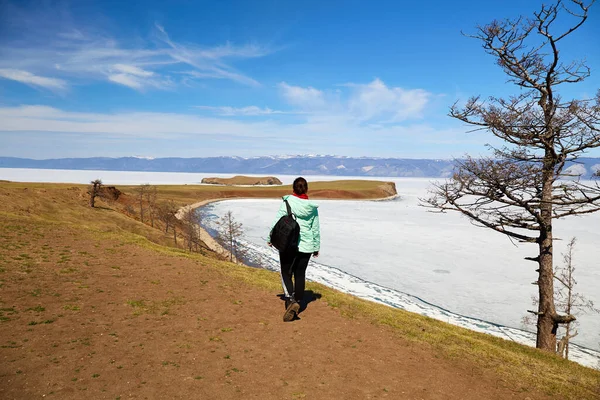 Lake Baikal in spring. The time of ice melting on the lake. A women traveling alone on Olkhon Island. — Stock Fotó