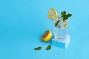 Limonatalı bir bardak ya da mavi arka planda naneli limonlu mojito kokteyli. Soğuk, ferahlatıcı bir yaz içeceği.. 