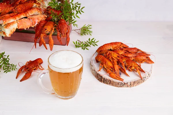 A mug of light beer with boiled crayfish and crabs. . High quality photo