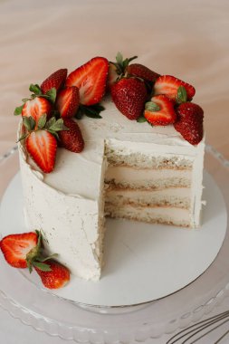 Masada bir parça çilekli tatlı beyaz pasta.