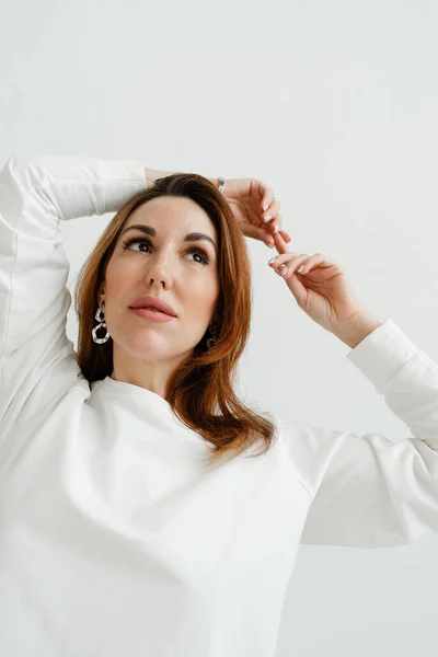 portrait of an iranian woman with red hair close-up of a beautiful girl in a white sweater