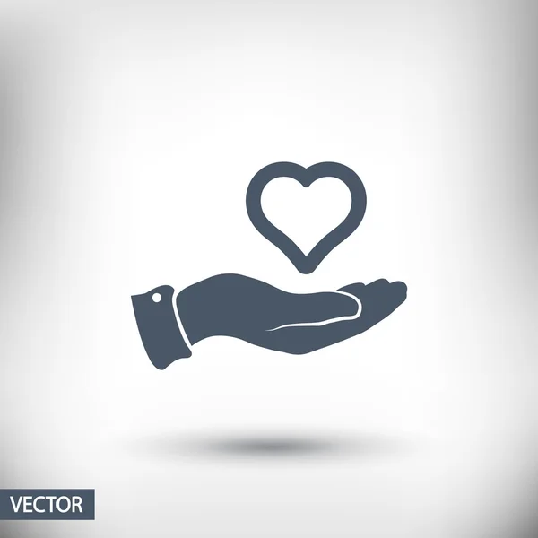 Heart in hand icon — Stock Vector