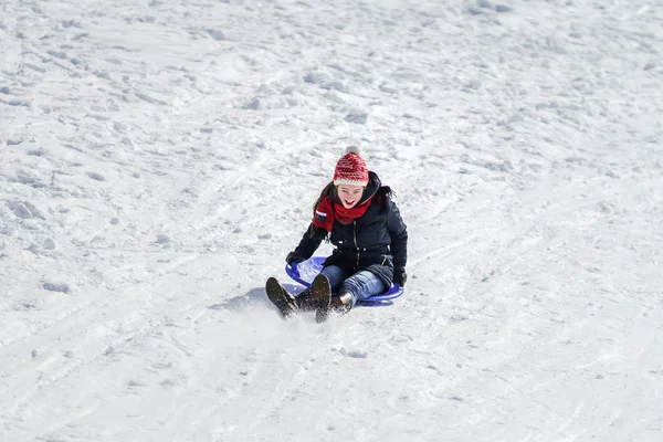 Teenage girl sledding from the hill — Stock Photo, Image