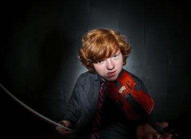 Freckled red-hair boy playing violin clipart