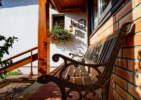 Elegant bench near the house, sunny day — Stock Photo, Image