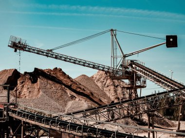 Ezilmiş taş, çakıl ve kum üretimi için bir bitki. Taş ocağı, makineler ve taşıyıcılar.