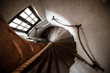 Zengin bir ortaçağ evinde eski bir sarmal merdiven. Alsace.